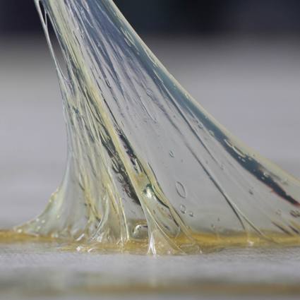 Adhesive substance stretching between two surfaces