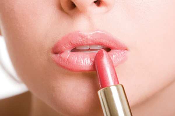 Applying lipstick